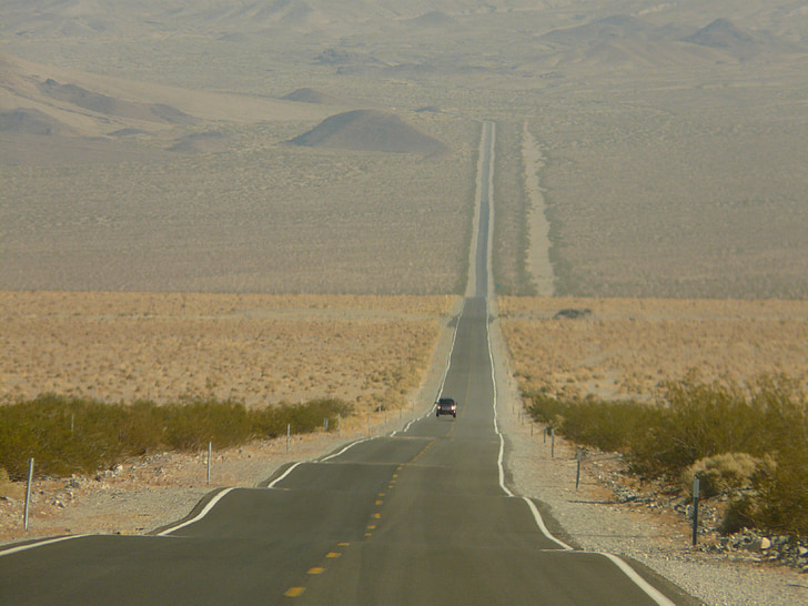 car driving on Death Valley road during daytime