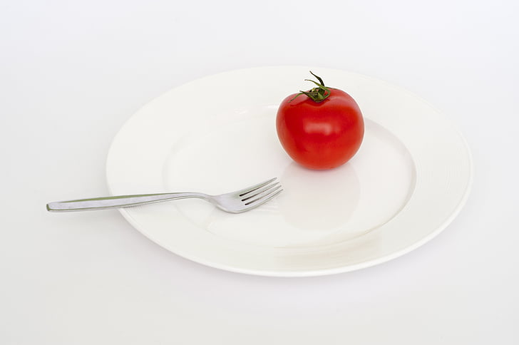 tomato on plate and fork