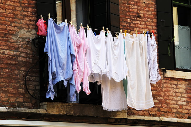 Royalty-Free photo: Women's clothing lot hanging beside window during  daytime