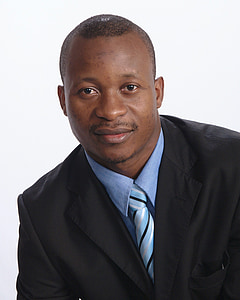 man wearing black suit jacket and blue striped necktie
