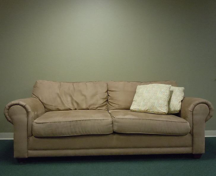photo of beige padded 2-seat sofa near wall