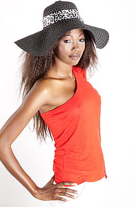 woman wearing red one-shoulder sleeveless top and black and white sunhat