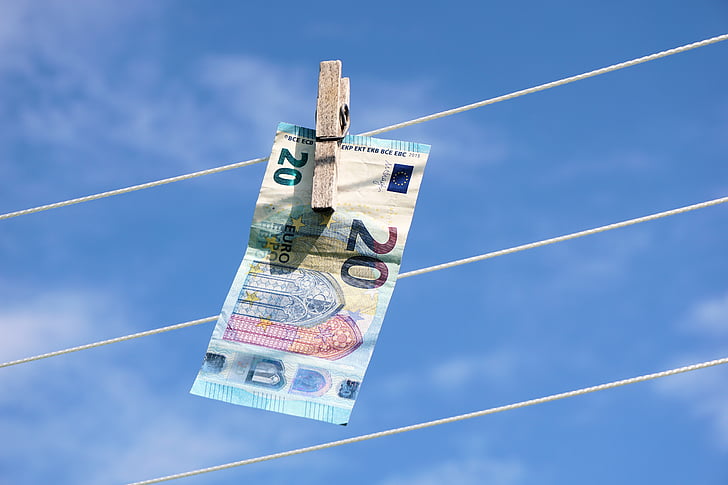 20 banknote hanging on white rope