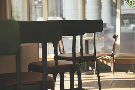 low angle photography of three black-and-red leather-padded wood-framed bar stools