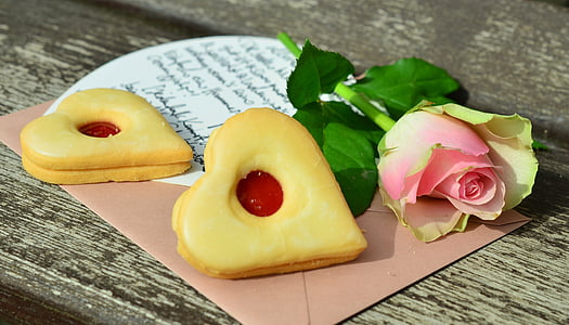 heart cookies near pink tulip rose