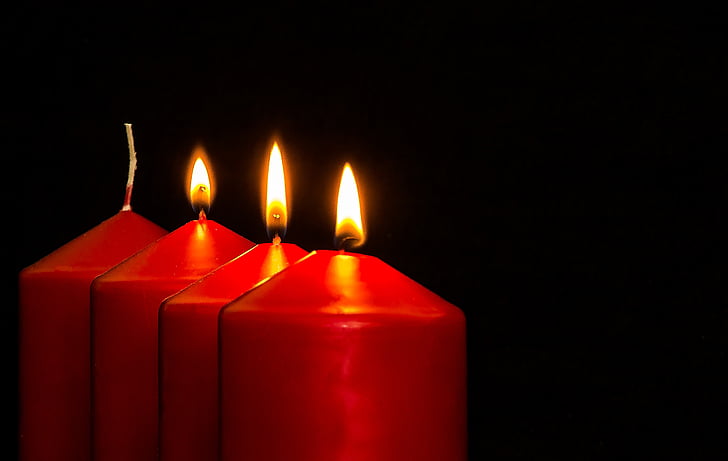 four red candles with lights