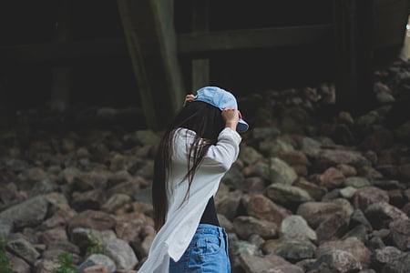woman wearing white cardigan and blue cap