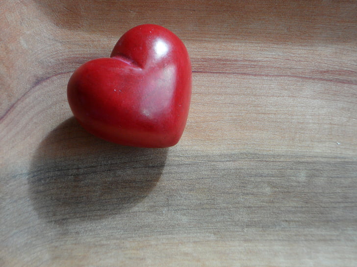 red heart on wooden surface