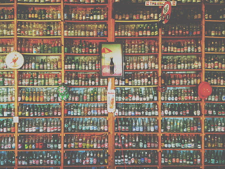assorted-color bottle in brown rack