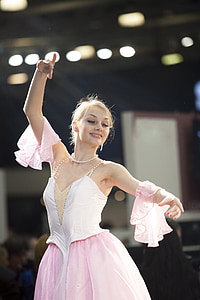 woman wearing pink dress while dancing