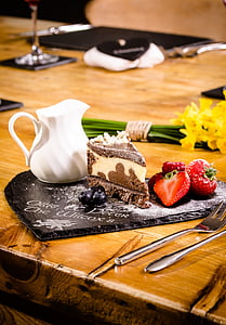 slice of brown and white cake on brown wooden top