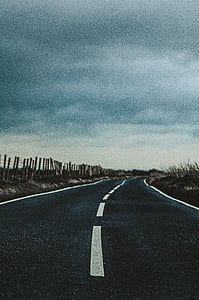 gray asphalt road under grey skies
