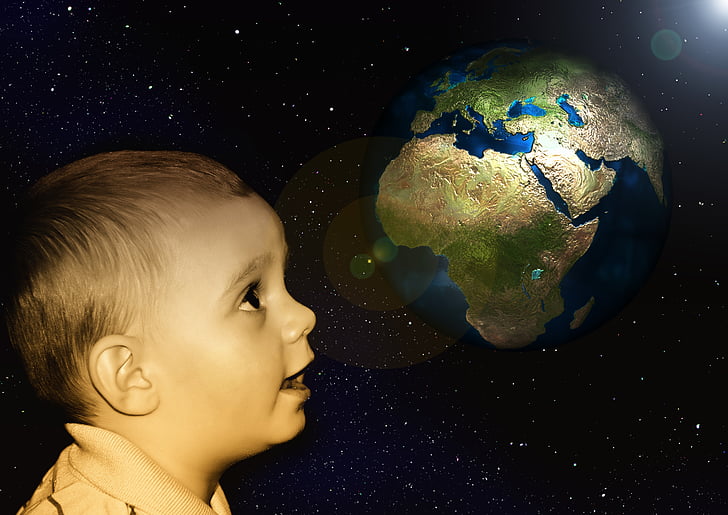 child staring at the planet earth