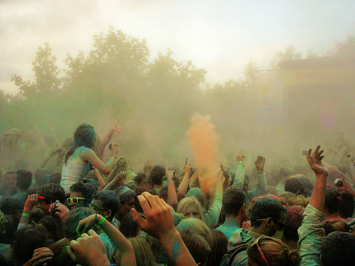 people gathering outside playing with color powders