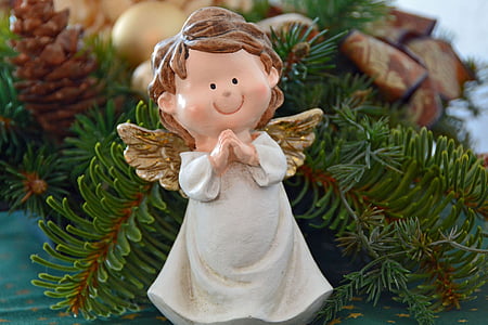 white and brown angel ornament on christmas tree