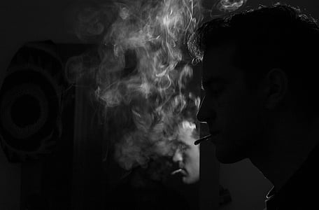 photo of man smoking cigarette