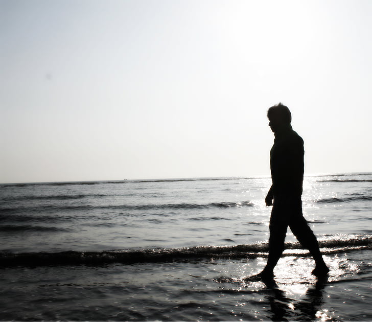 silhoutte of person near body of water