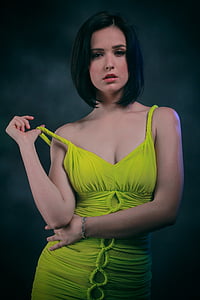 woman in green dress holding her dress's strap