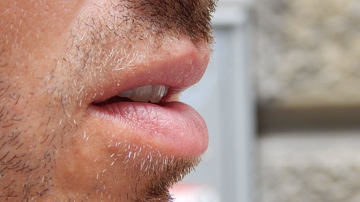 closeup photo of person's mouth