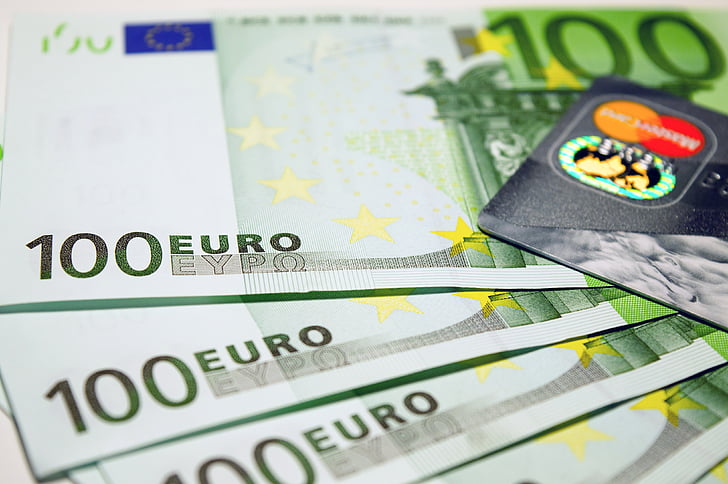four 100 Euro banknotes and MasterCard card