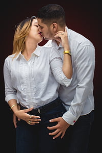 man and woman kissing