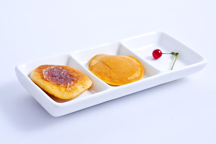 three slotted tray with pancakes and cherry