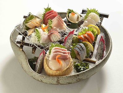 sashimi served on white ceramic pot