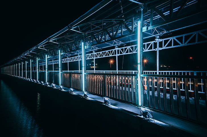 brown concrete bridge with LED lights during nighttime