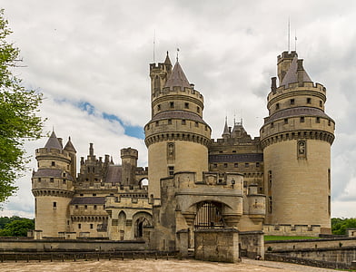 beige and gray concrete castle under white cloudy sky at daytime