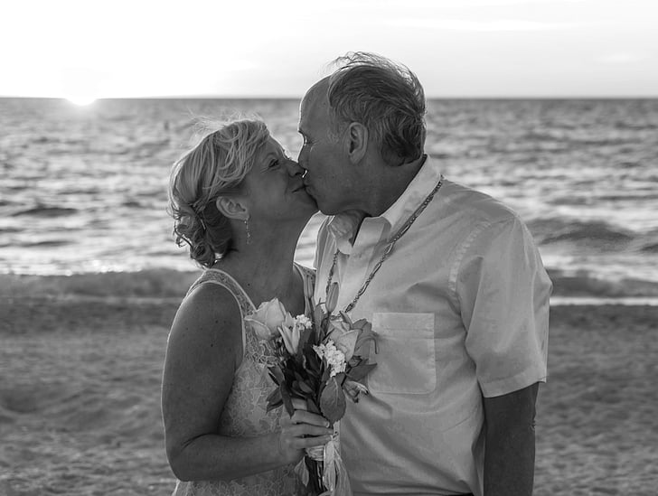 couple kissing near seashore