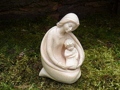 ceramic woman and child figurine on green grass