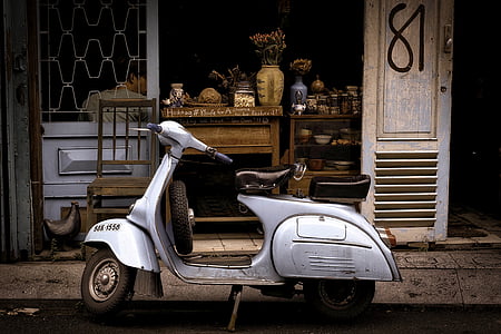gray motor scooter parked infront of store