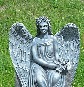 shallow focus photography of angel concrete statue