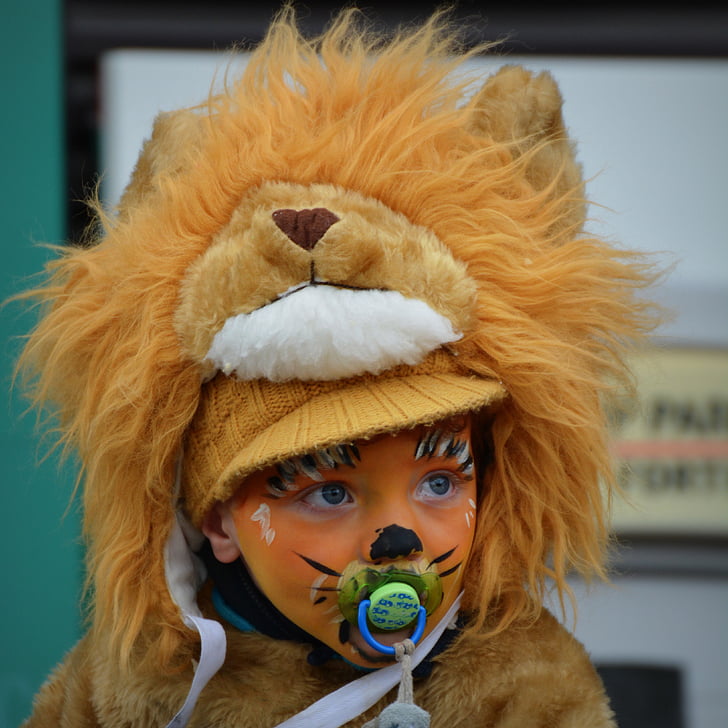 portrait photography of child in lion costume