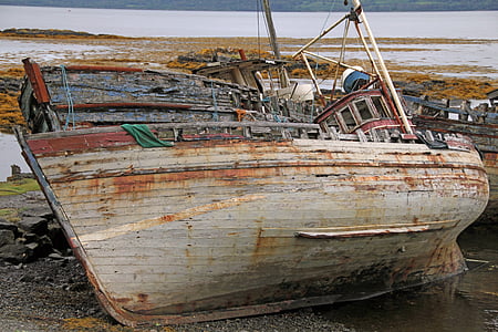 rusted white boat on land