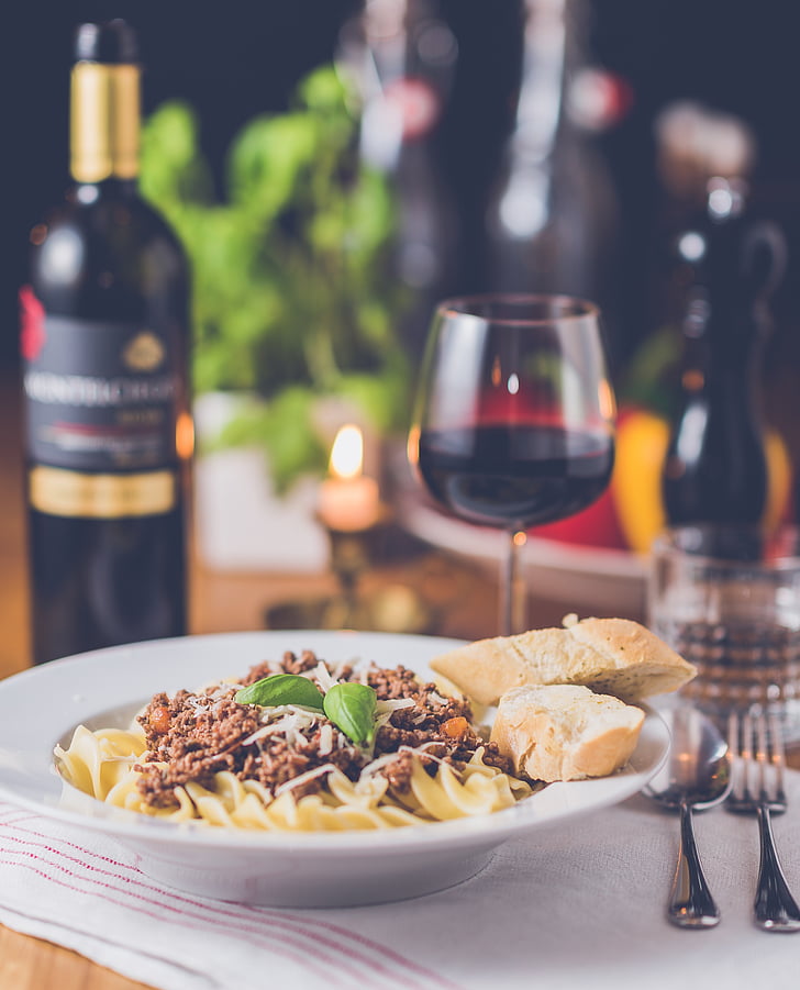 cooked pasta with bread and red wine