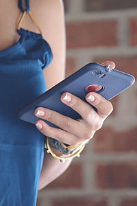 woman holding iPhone with blue case