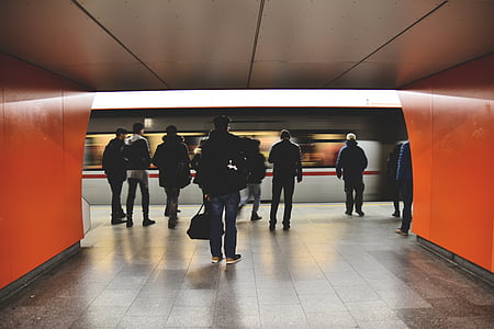 group of people walking near moving train