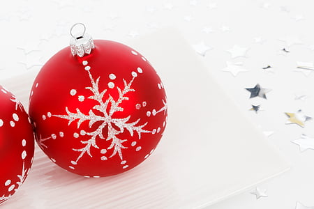 two red-and-gray baubles on white board