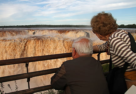 man and woman facing on Niagara Falls at daytime