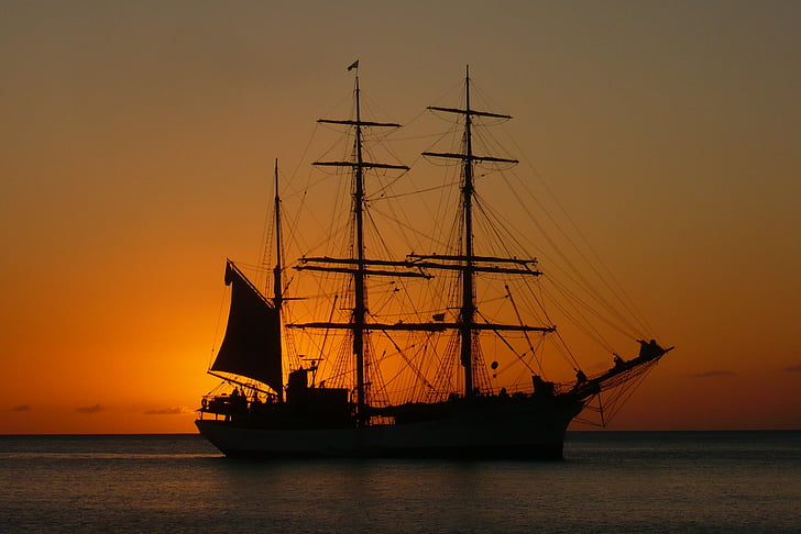 silhouette of galleon ship during sunset