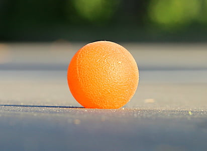 orange ball on gray board