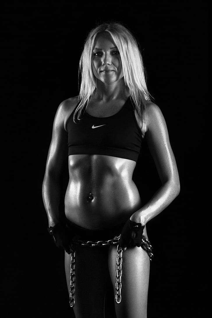 grayscale photo of woman in black Nike sports bra
