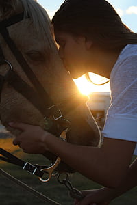 woman kissing horse