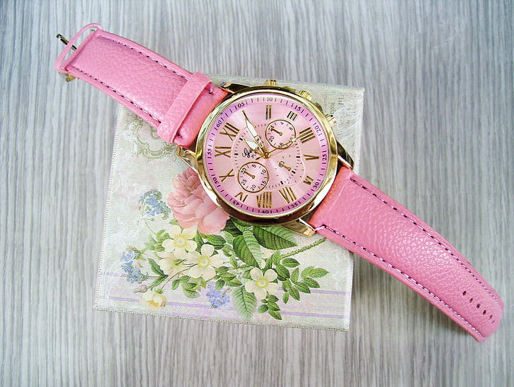 photo of round gold-colored bezel pink face chronograph watch