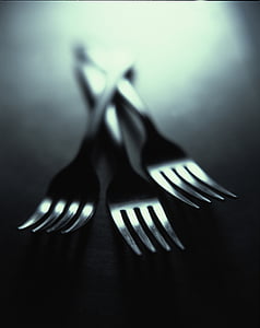 shallow focus photography of three stainless steel forks
