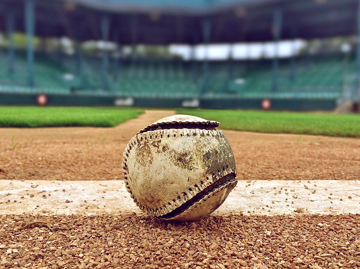 selective focus photography of white baseball inside the stadium