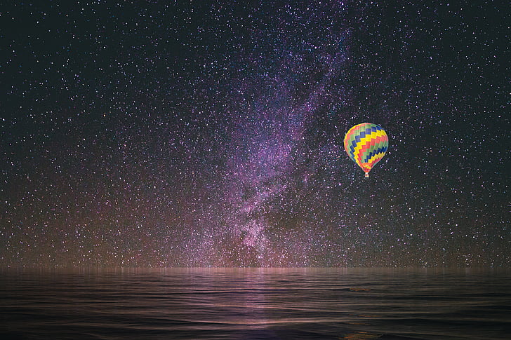 multicolored hot air balloon sailing during nighttime