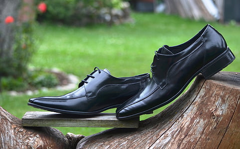 pair of black leather dress shoes