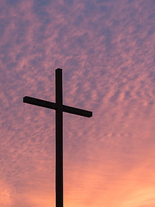 silhouette of cross under white sky